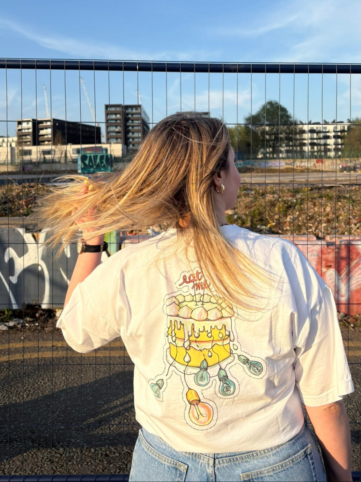 Woman wearing an oversized organic cotton t-shirt with a science-inspired back illustration designed to raise awareness about GSDs - The Shapes Of